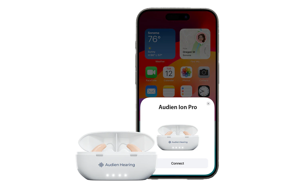 White Audien Ion Pro earbuds with charging case on a smartphone screen displaying the Audien app.